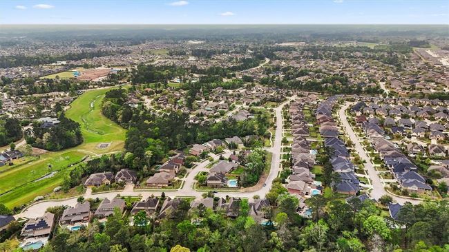 Aerial view of The Falls at Imperial Oaks showcases this master-planned community’s natural beauty, greenbelt trails, and resort-style amenities—all surrounded by lush trees and thoughtfully designed homes. | Image 41