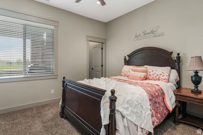 Bedroom featuring a ceiling fan, baseboards, and carpet floors | Image 25
