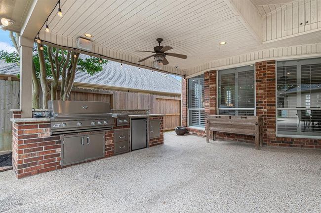 This outdoor kitchen is sure to add to your backyard gatherings, whether it's grilling burgers or for grabbing a drink from the refrigerator! | Image 39