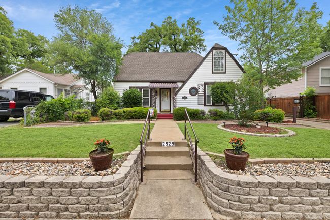 View of front of home featuring roof with shingles, fence, and a front yard | Image 13