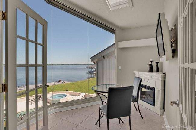 Sunroom featuring a hot tub and plenty of natural light | Image 19