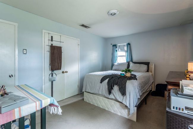 Carpeted bedroom with a closet | Image 14