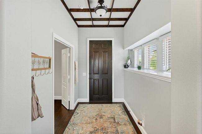 Entryway featuring dark wood-type flooring, coffered ceiling, and beamed ceiling | Image 6