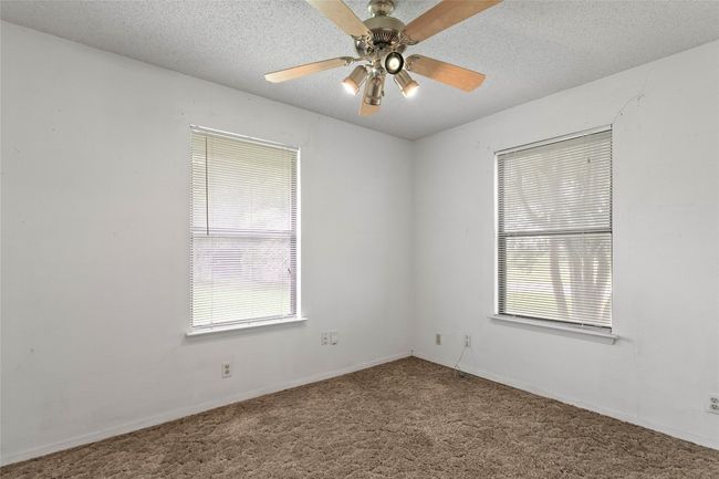 Unfurnished room with carpet flooring, a textured ceiling, and a ceiling fan | Image 18
