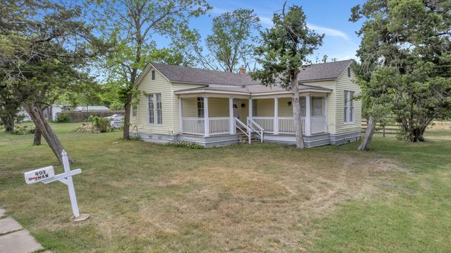 Bungalow with a shingled roof, a front lawn, and covered porch | Image 24