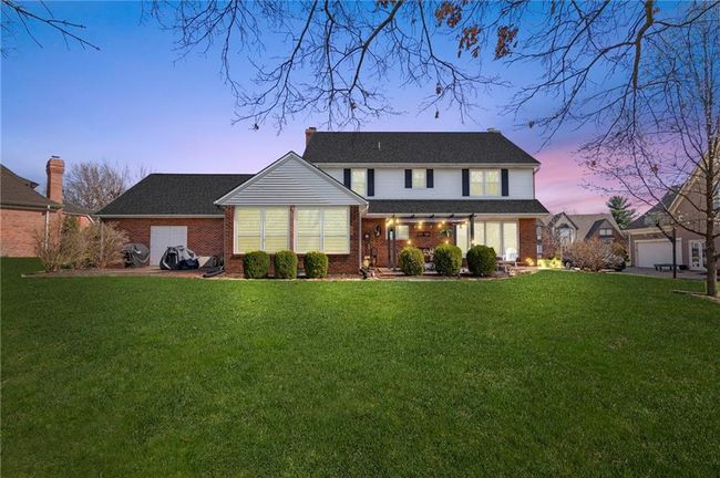 Back house at dusk featuring a yard and a garage | Image 53