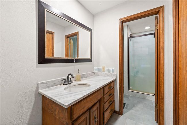 Full bathroom with a stall shower and vanity | Image 23