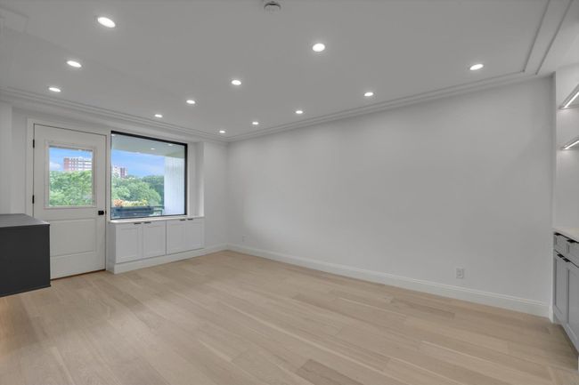 Empty room featuring light wood-style flooring, recessed lighting, crown molding, and a smoke detector | Image 7