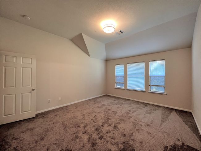 Spare room with carpet floors, lofted ceiling, and a smoke detector | Image 8