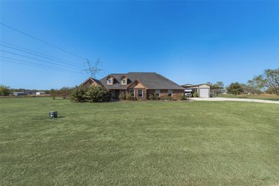 View of front of property featuring a front yard and a garage | Image 3