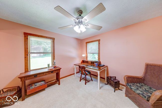 carpeted office space featuring healthy amount of natural light and a ceiling fan | Image 31