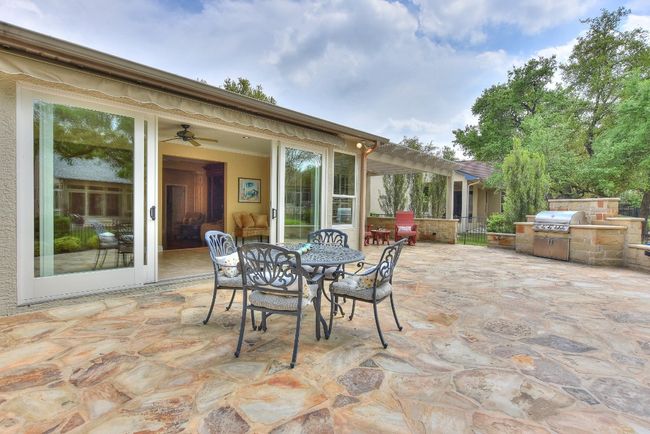 View from the patio back towards the home shows awning overhead for sunny days. | Image 24