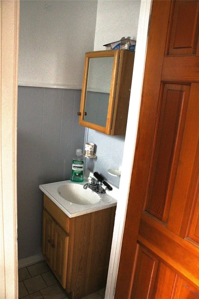 Half Bathroom with vanity and tile patterned floors | Image 9