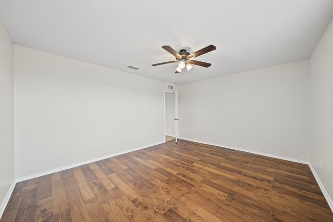Spare room with a ceiling fan and dark wood-style floors | Image 30