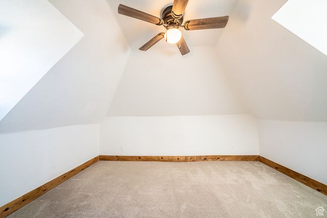 Bonus room featuring vaulted ceiling, carpet floors, ceiling fan, and baseboards | Image 17