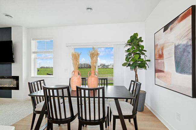 (Photo of decorated model, actual home's finishes will vary) Soaked in natural sunlight, the homes eat-in dining room has ample space for a dining table located in the heart of the home. | Image 6