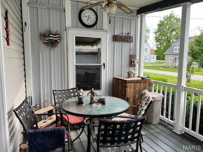 Wooden terrace featuring ceiling fan and outdoor dining area | Image 17