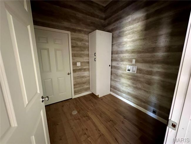 Entryway featuring wooden walls and dark wood-style flooring | Image 11