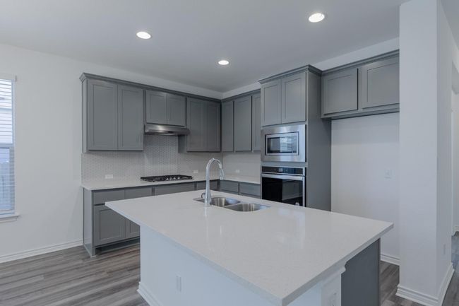 Kitchen featuring a sink, stainless steel appliances, and gray cabinets | Image 16