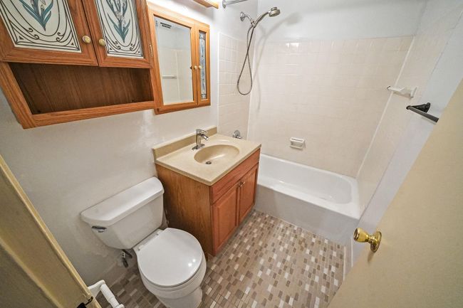 Full bathroom with toilet, vanity, shower / bath combination, and tile patterned flooring | Image 11