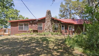 This charming fishing cabin has 4 bedrooms or use the big one as a den overlooking the lake | Image 1