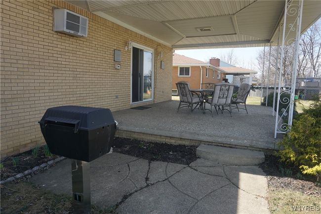 Beautiful covered rear patio for relaxing & entertaining! Built in gas grill. | Image 4