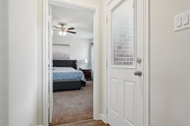 Hall with dark wood finished floors and a textured wall | Image 27