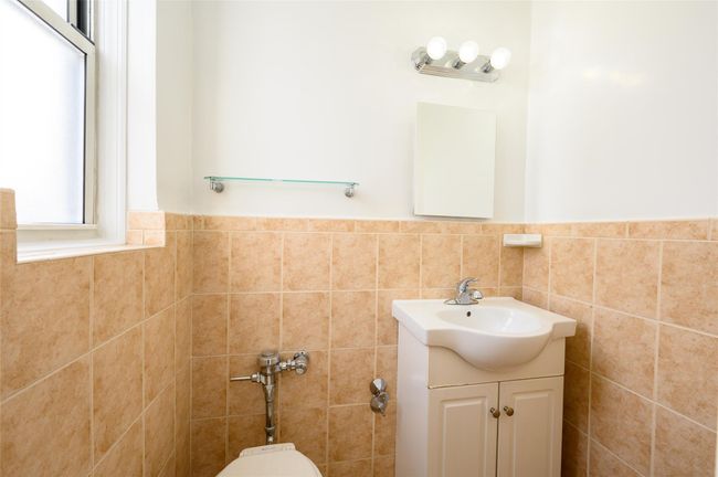 Bathroom featuring vanity, toilet, and tile walls | Image 14