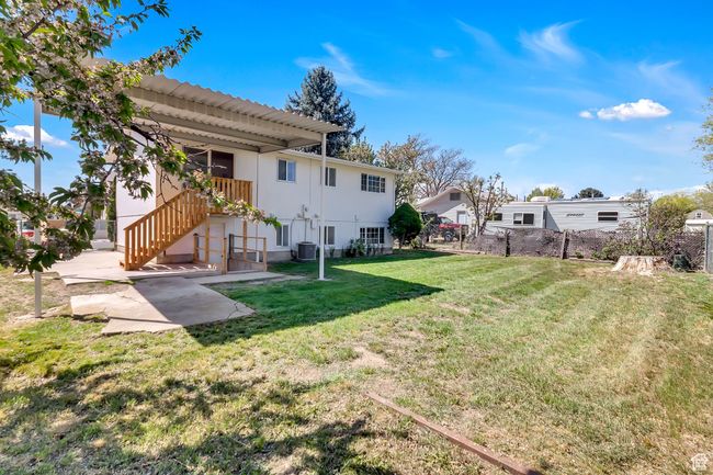 View of yard with central AC, fence, and stairs | Image 24
