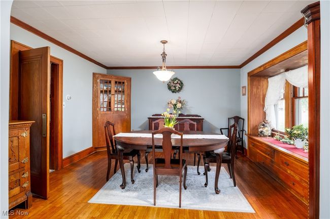 Dining area featuring hardwood / wood-style floors, baseboards, and ornamental molding | Image 9