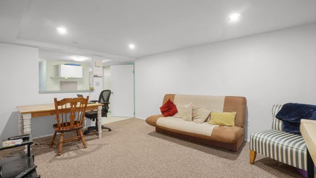Rear view of house featuring a wooden deck, cooling unit, and a lawn | Image 27