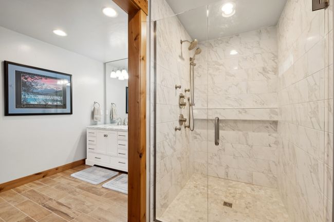 Bathroom featuring a shower with door and vanity | Image 52