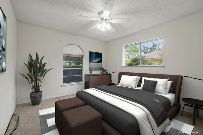 Carpeted bedroom featuring a textured ceiling and ceiling fan | Image 6