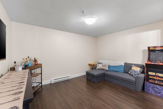 Living room featuring baseboard heating, baseboards, and wood finished floors | Image 12