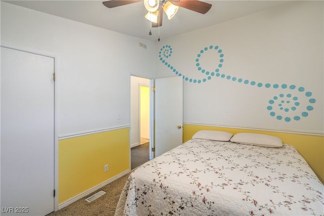 Carpeted bedroom with a ceiling fan and baseboards | Image 22