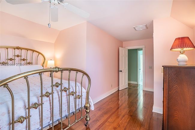 Bedroom featuring ceiling fan, dark hardwood / wood-style floors, and vaulted ceiling | Image 37