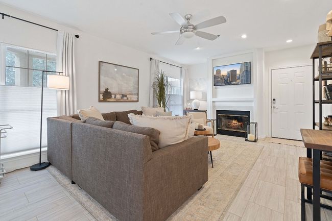 Spacious living room with beautiful floors and ambient natural lighting. | Image 4