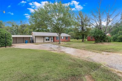 Ranch-style home with a carport and a front yard | Image 2