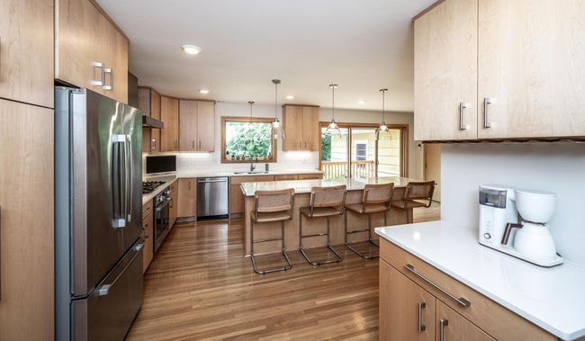 Nook just of the kitchen includes additional cabinets, counter space & a large panty with roll out shelving. | Image 6