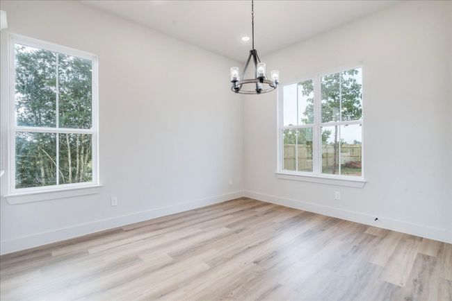 Unfurnished room with a chandelier, light wood-type flooring, and recessed lighting | Image 12