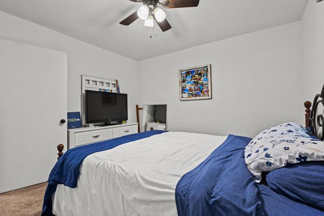 Bedroom with carpet flooring and a ceiling fan | Image 29