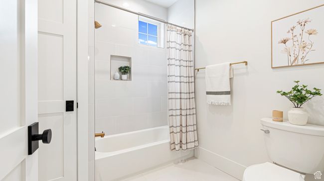 Bathroom featuring toilet and shower / bath combo with shower curtain | Image 37
