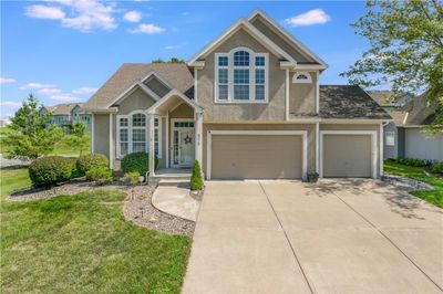 View of front of property with a front yard and a garage | Image 3