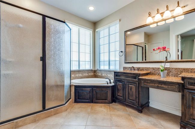 Full bath with tile patterned floors, a garden tub, vanity, and a shower stall | Image 26