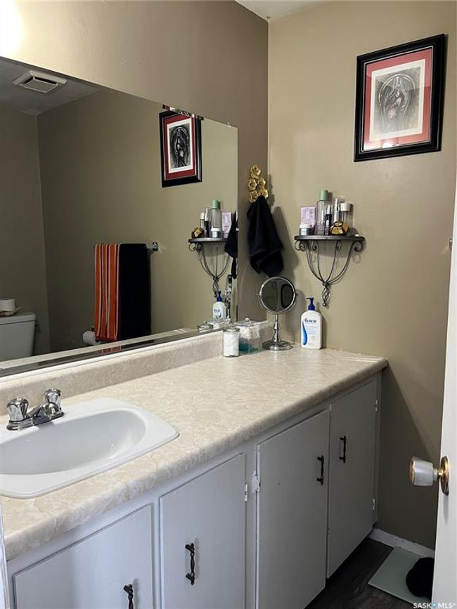 Bathroom with baseboards, visible vents, toilet, and vanity | Image 32