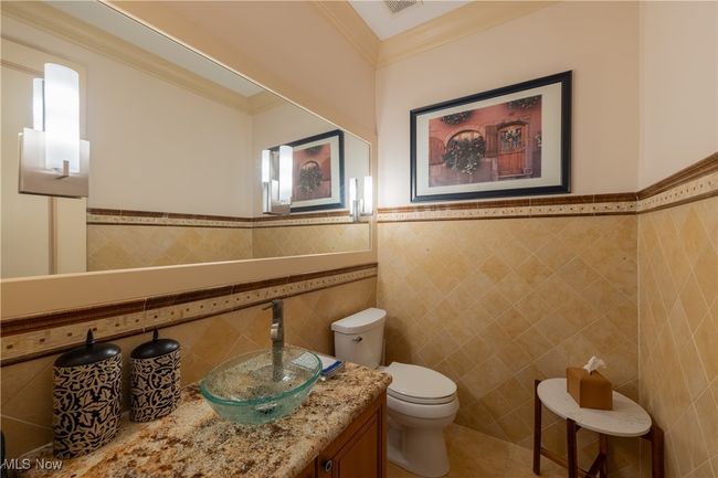 Powder room off foyer near den | Image 23