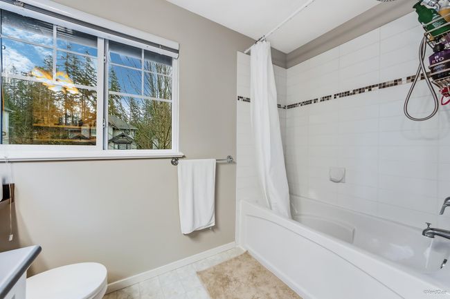 Full bath featuring baseboards, toilet, shower / bath combo, and tile patterned flooring | Image 19