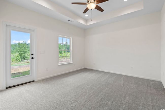 Empty room with carpet floors, baseboards, ceiling fan, and recessed lighting | Image 16