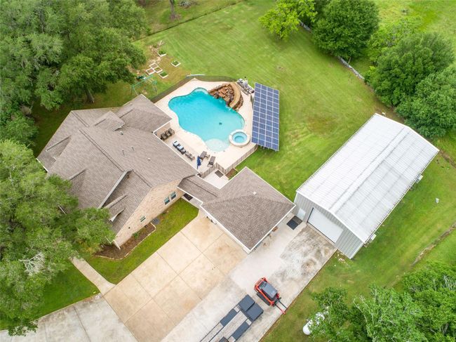 Tucked away on 1.5 serene acres in Manvel, this distinctive property is built for the way you want to live. The flexible floorpan allows between 4 to 6 bedrooms, 2.5 baths, a 2-car garage, in-ground pool, plus a 60'x30' insulated shop. | Image 45