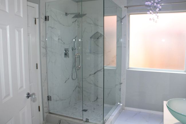Bathroom with a marble finish shower, baseboards, and marble finish floor | Image 24
